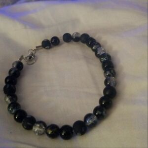 Handmade bracelet it's beaded black and gray. Adorable with every penny